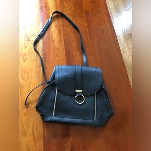 Convertible man made black leather handbag/backpack